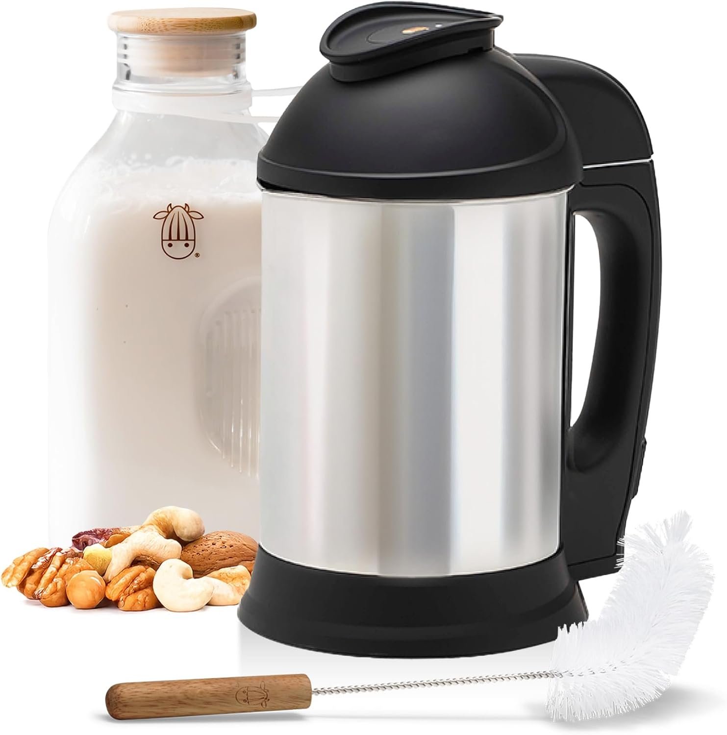 Almond Cow stainless steel nut milk maker beside a glass milk pitcher